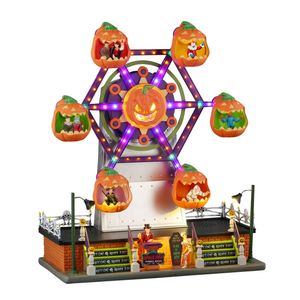Halloween-themed miniature ferris wheel with pumpkin carvings and lights on a white background